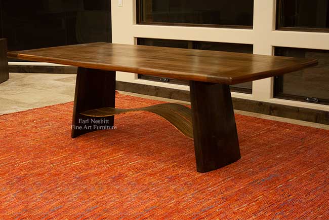 modern designer dining table installed showing sculpted alder legs with wavy zebrawood slats